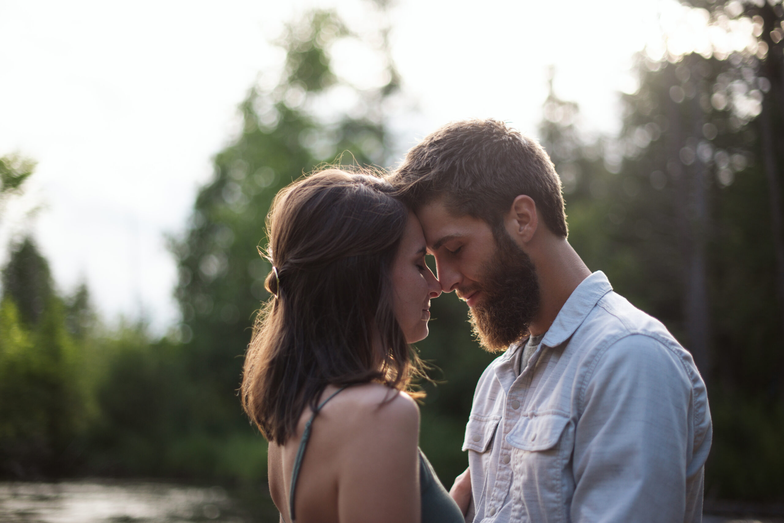 man and woman standing forehead to forehead during traverse city engagement session
