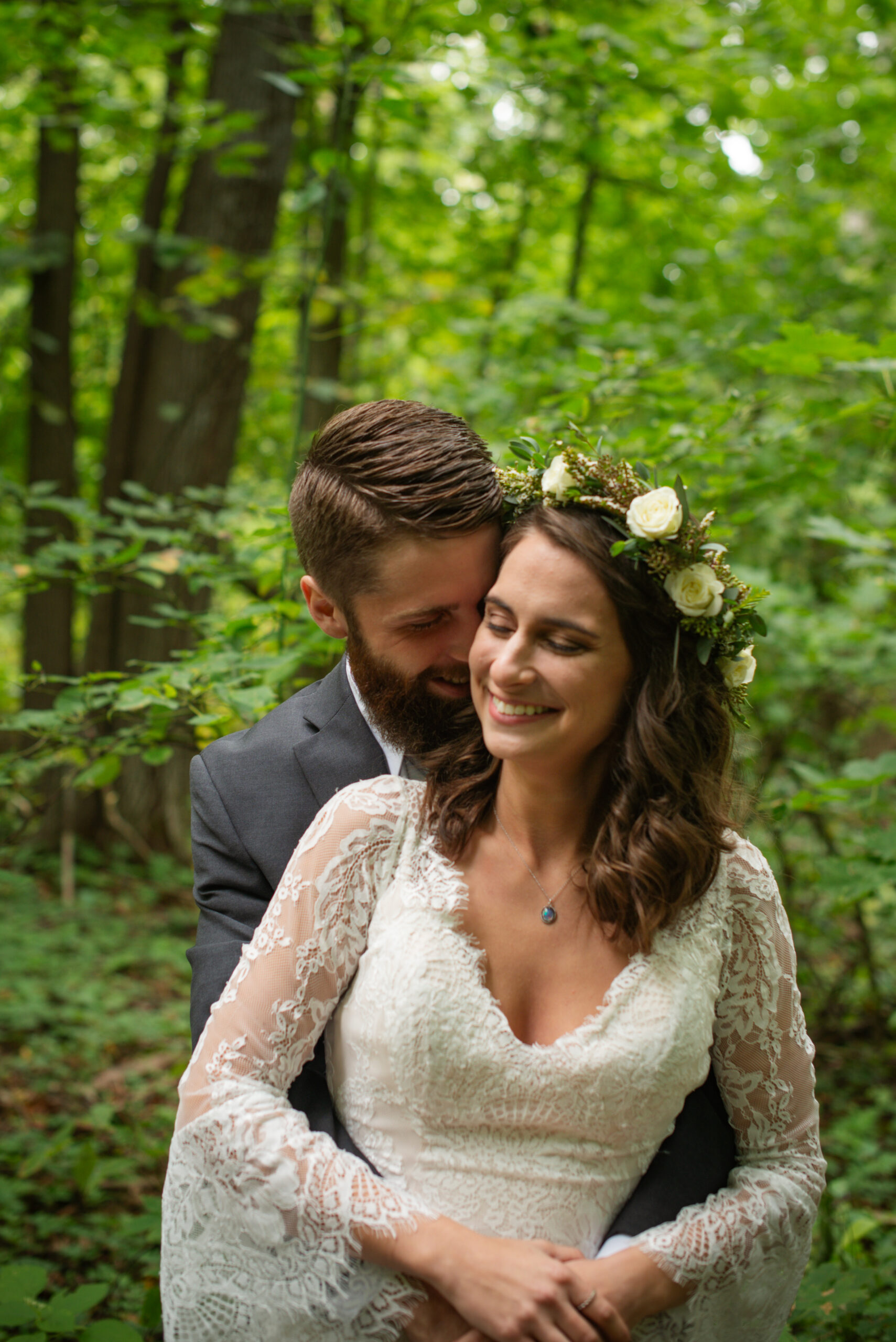 groom holding bride during wedding at twin lakes campground in traverse city
