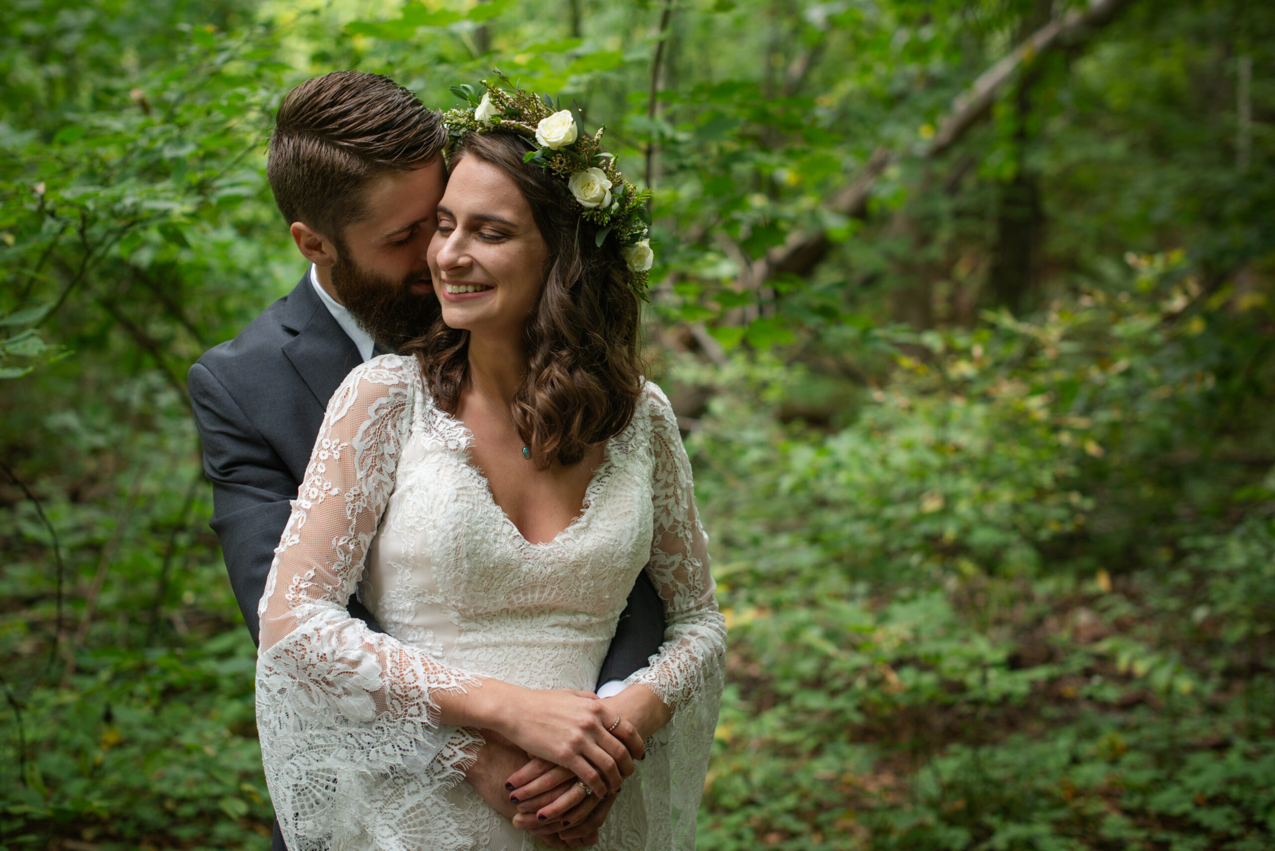 groom holding bride during wedding at twin lakes campground in traverse city