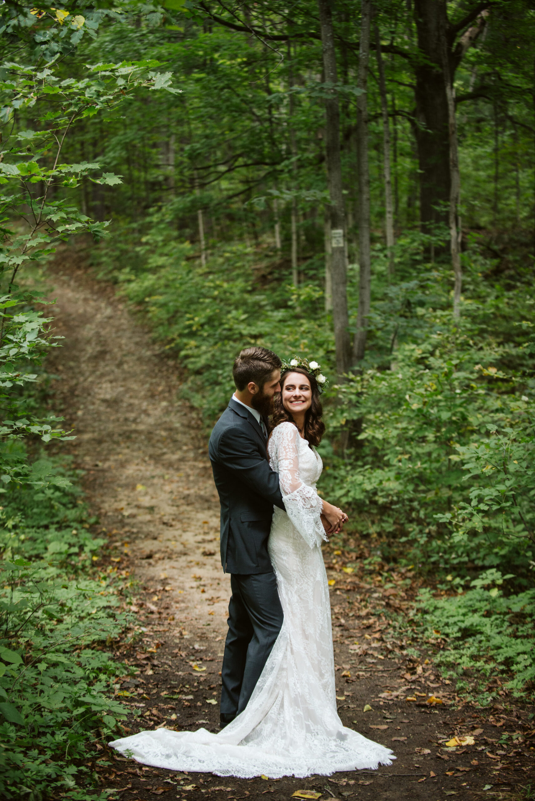 bride. and groom in woods during wedding at twin lakes campground in traverse city