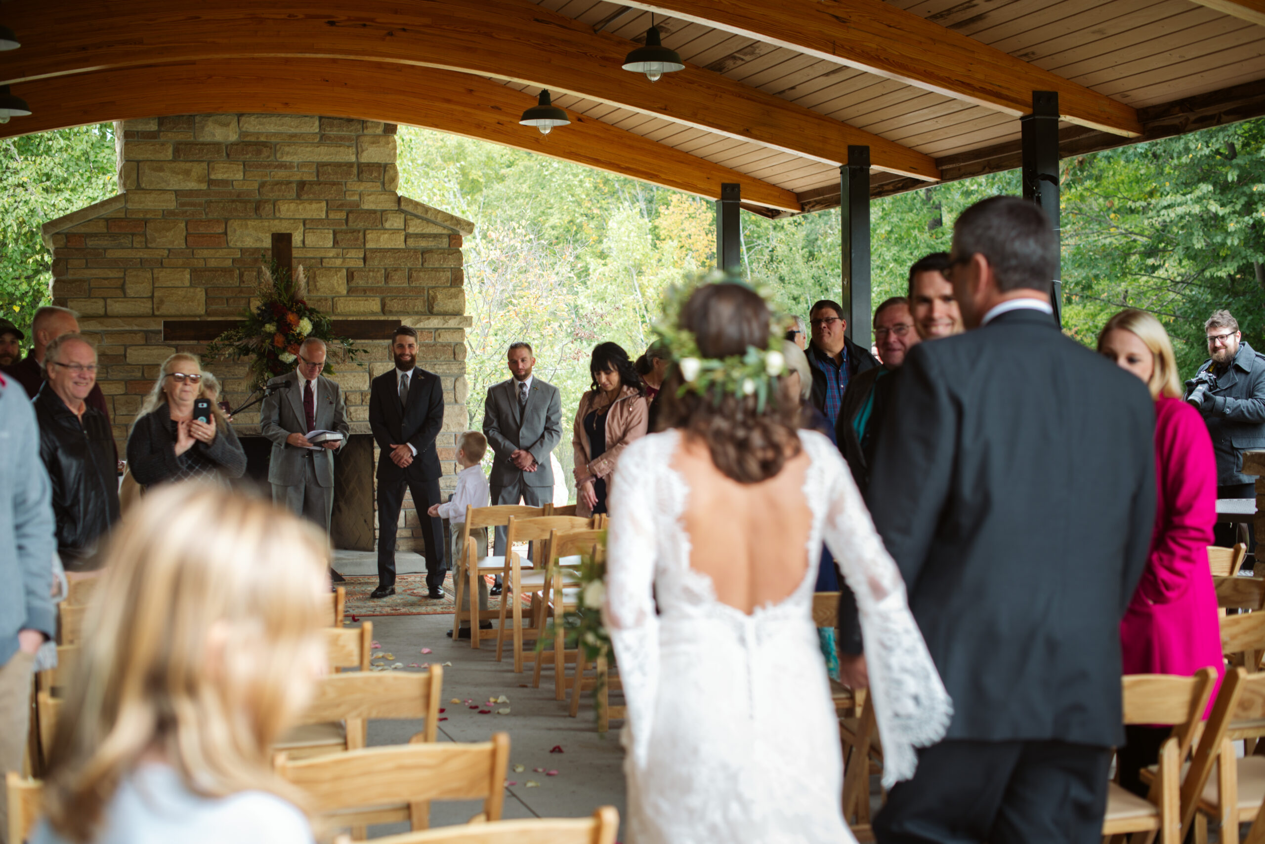 bride and father walking down aisle during wedding at twin lakes campground in traverse city