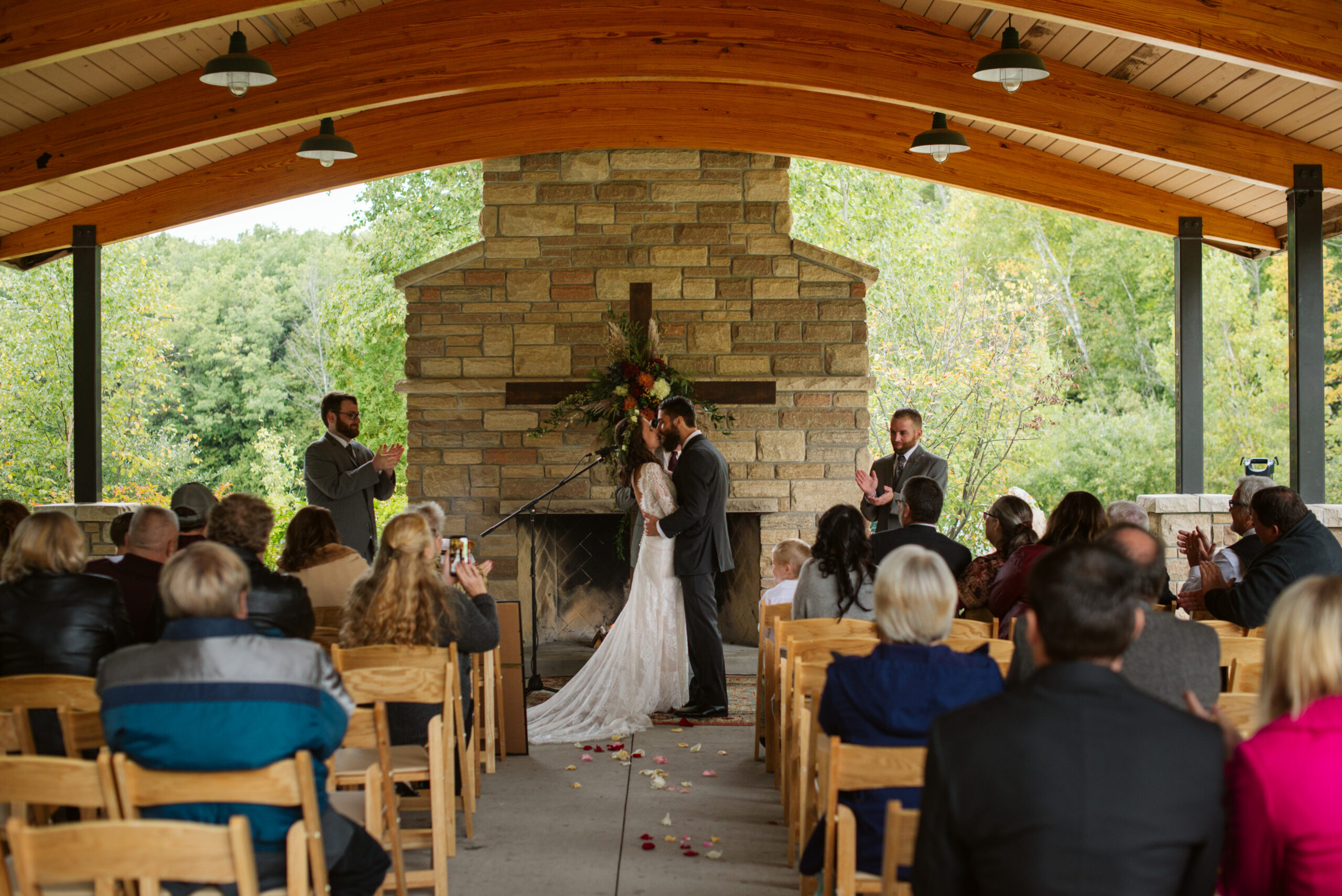 first kiss during ceremony during wedding at twin lakes campground in traverse city