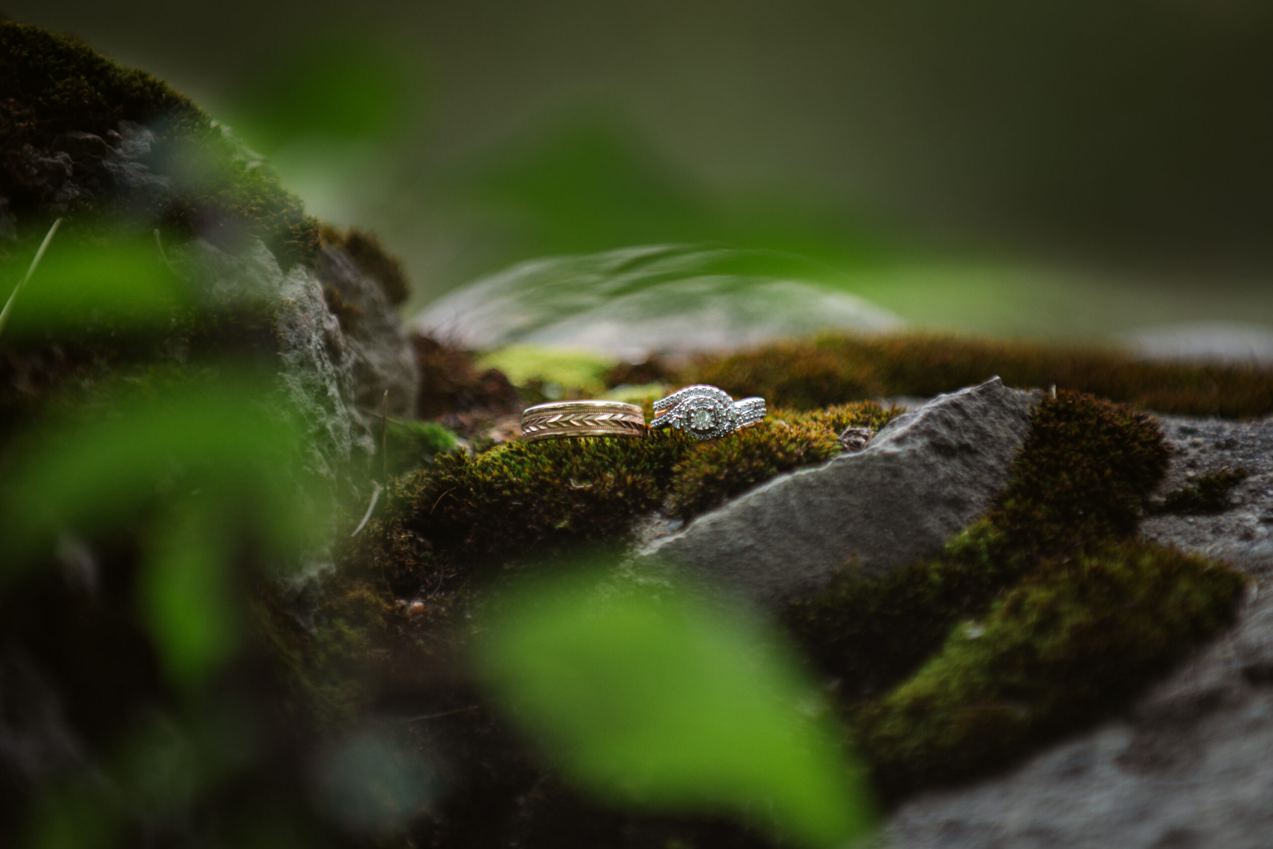 rings sitting on rocks during wedding at twin lakes campground in traverse city