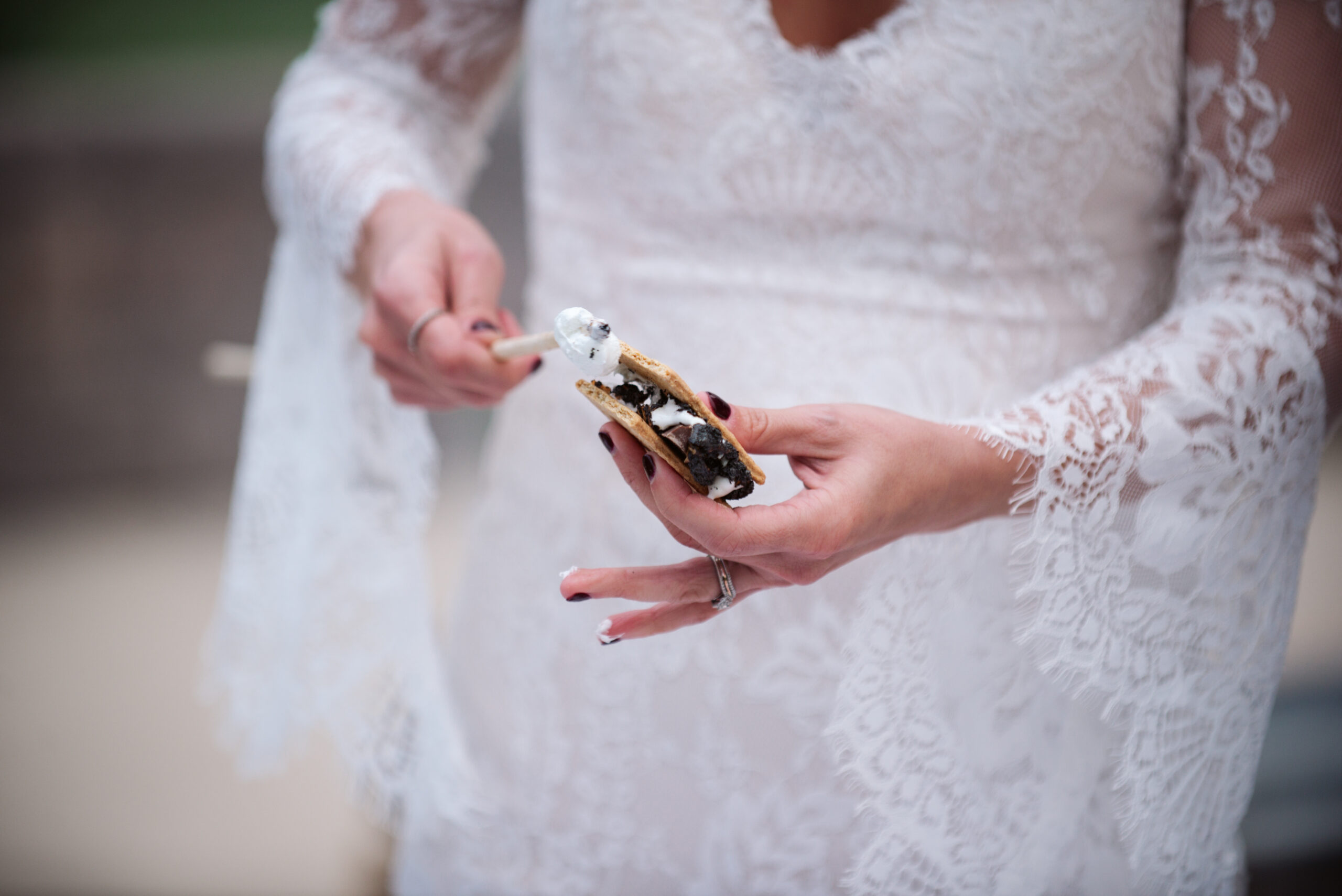 bride eating smore during wedding at twin lakes campground in traverse city