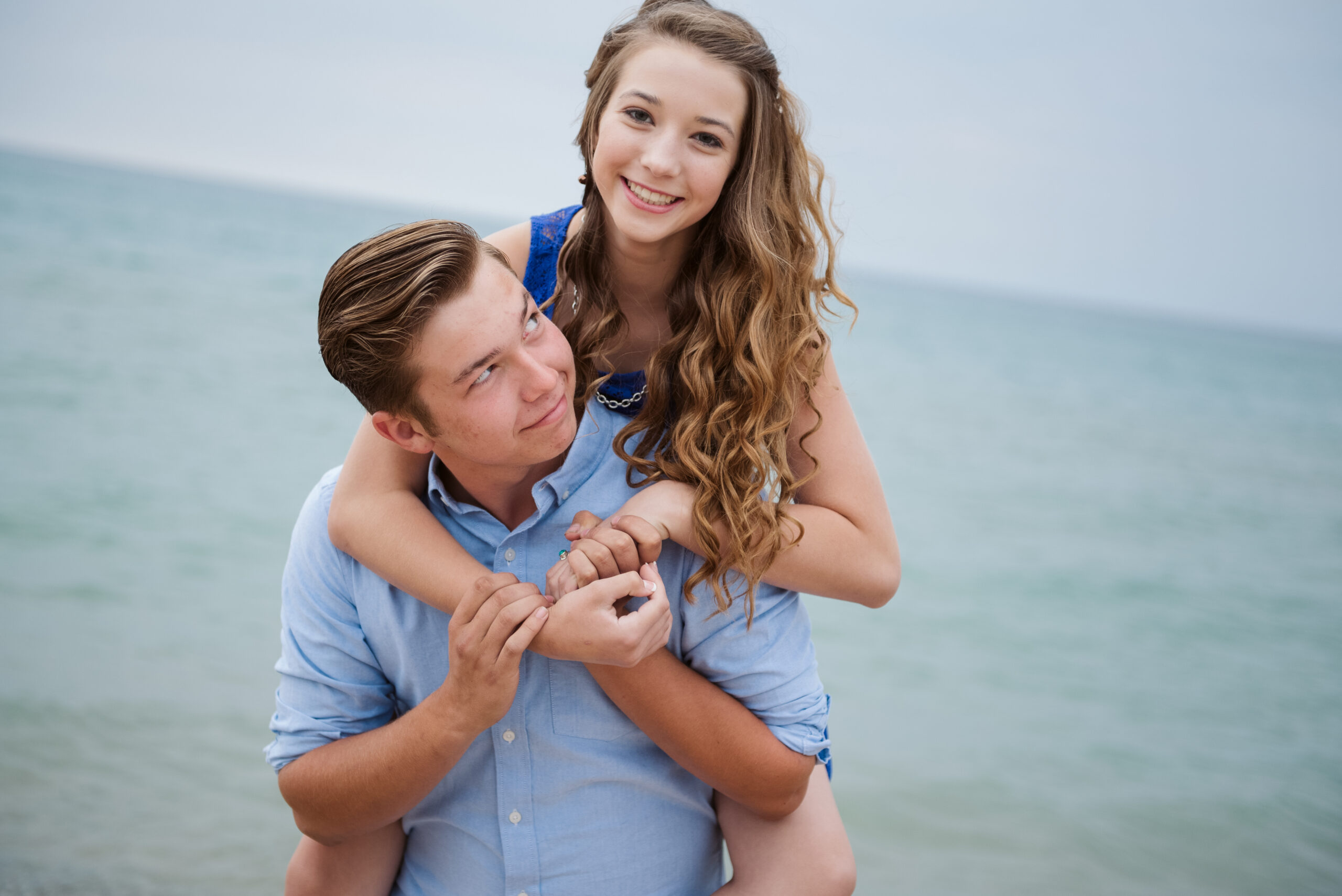 brother and sister on lake michigan family taking family photos with traverse city photographer