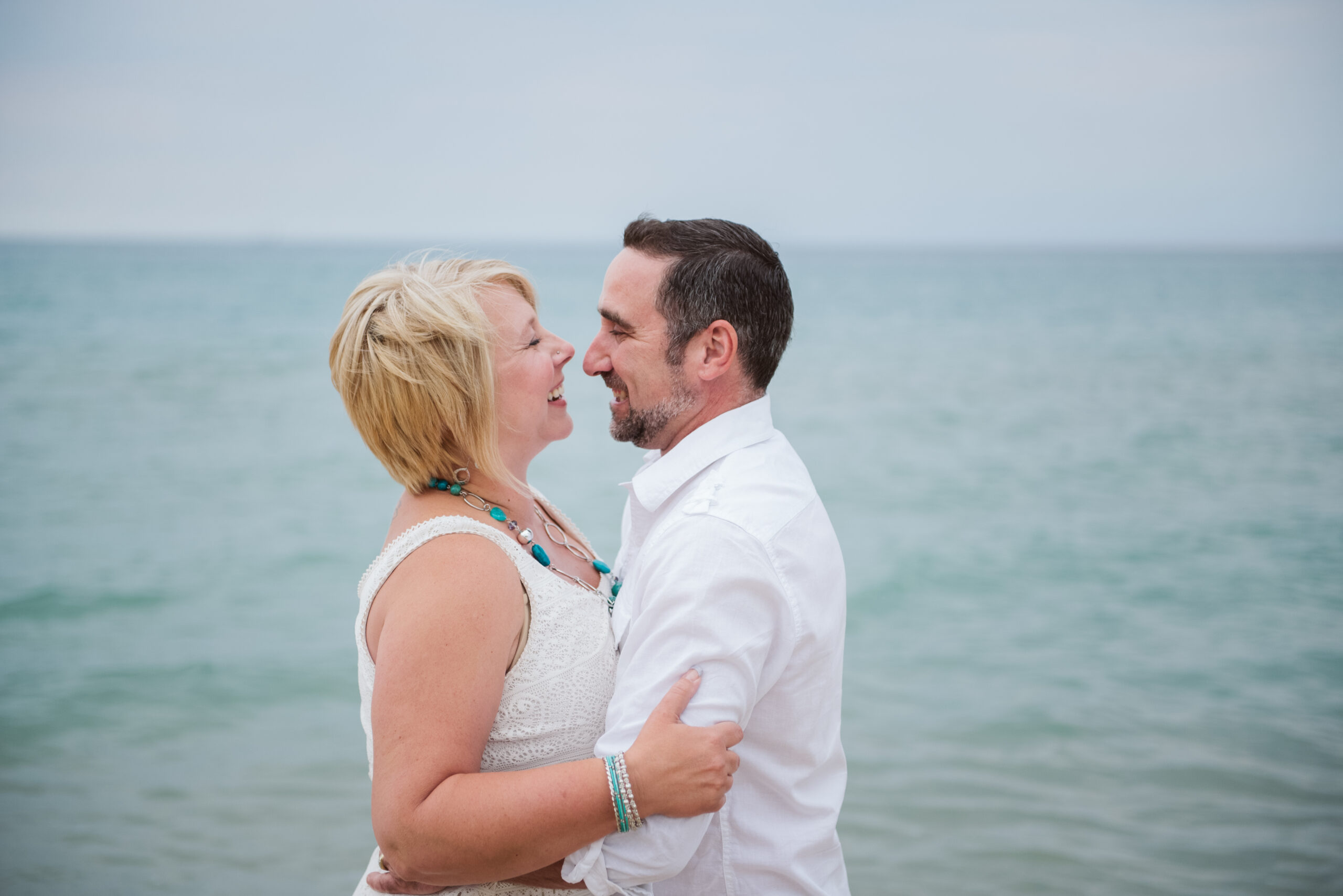 husband and wife on lake michigan family taking family photos with traverse city photographer