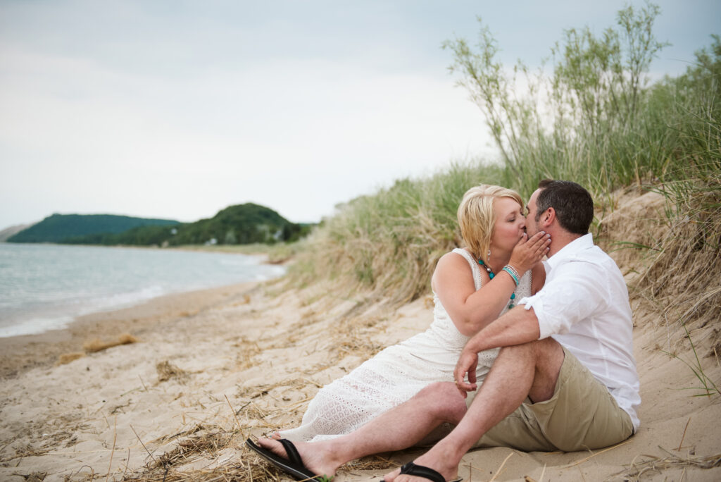 husband and wife on lake michigan family taking family photos with traverse city photographer
