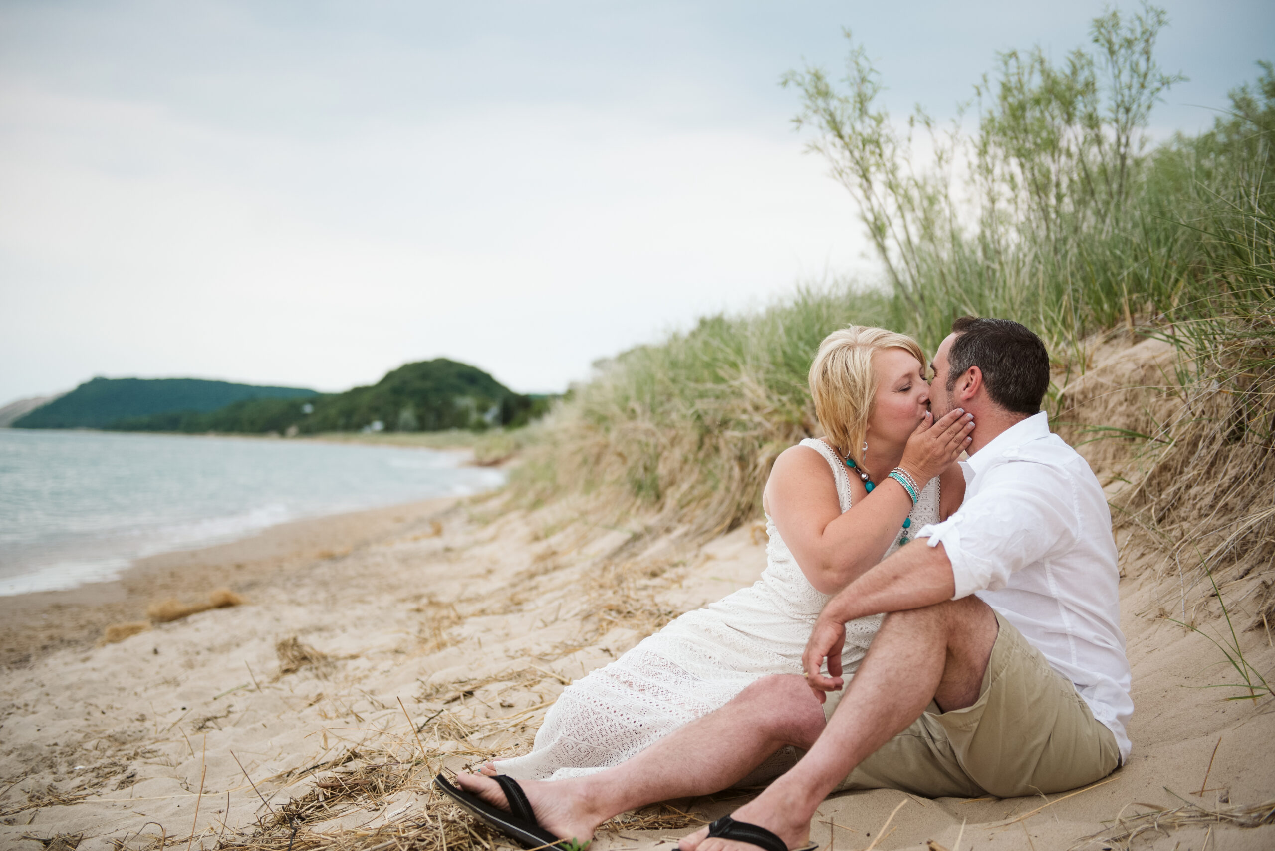 husband and wife on lake michigan family taking family photos with traverse city photographer
