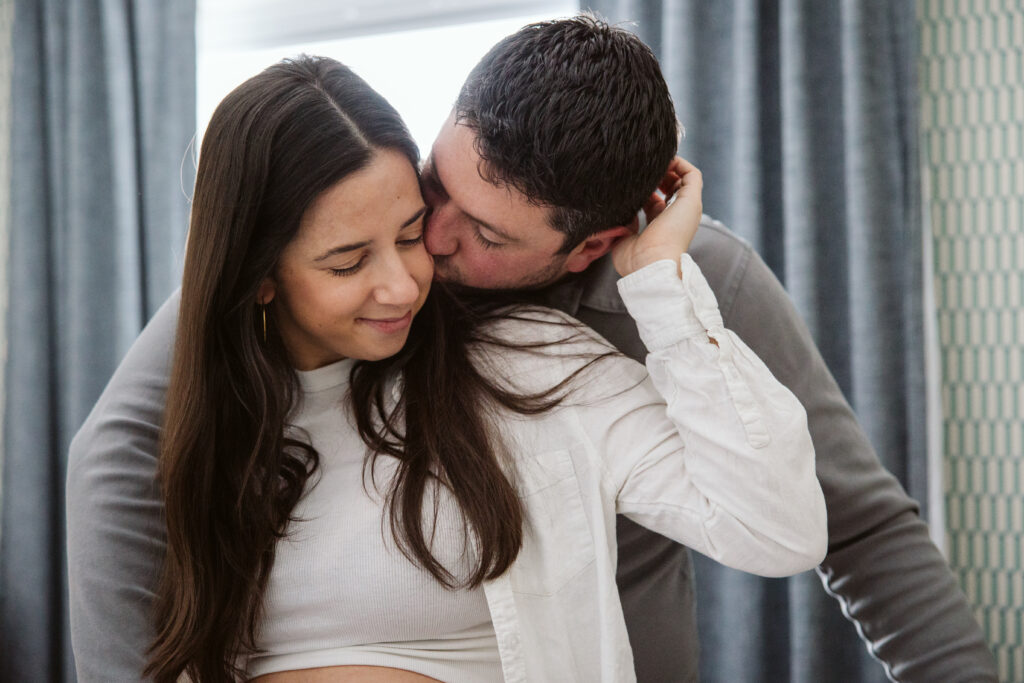 husband and wife durning home maternity photos in traverse city michigan
