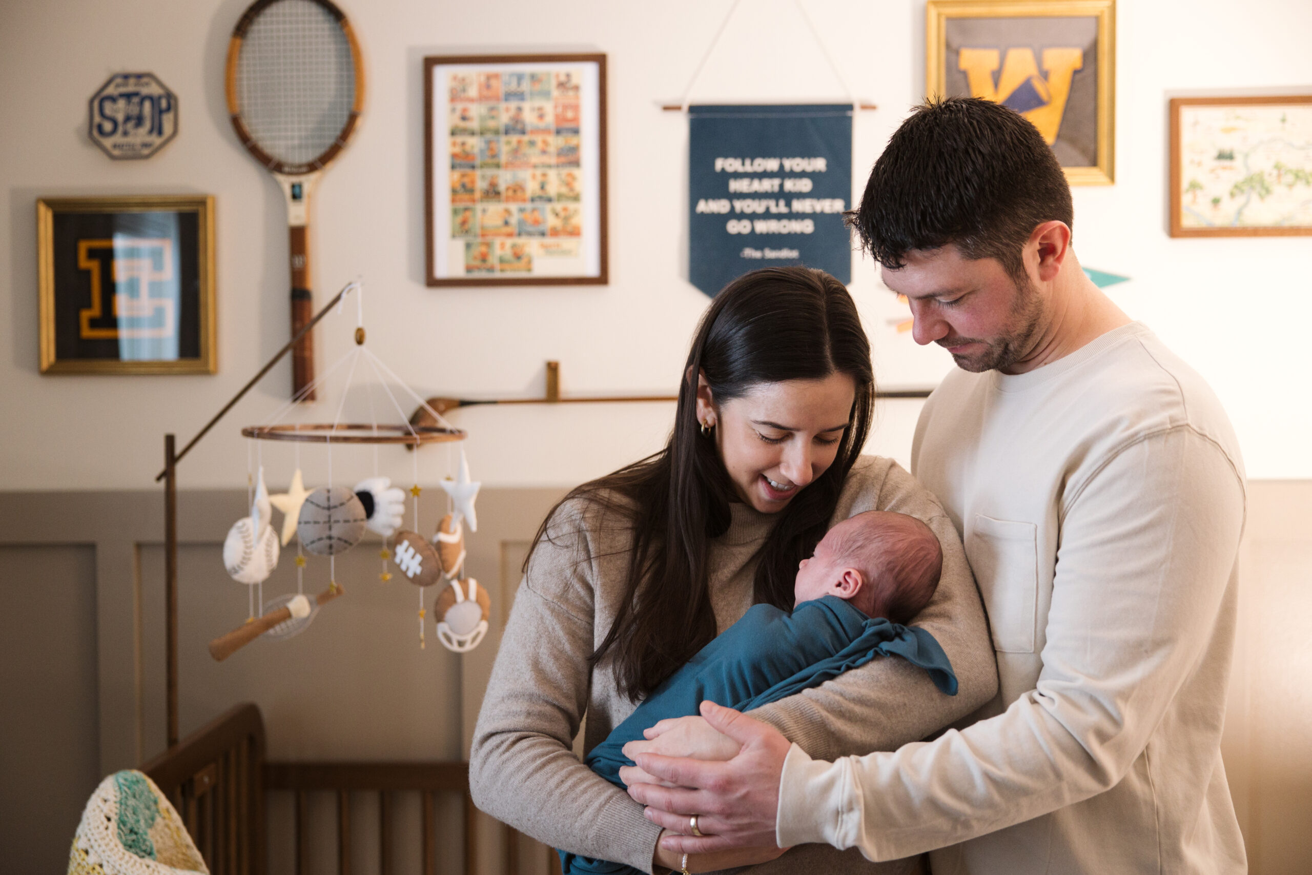 Traverse-city-michigan-newborn-photographer husband and wife holding baby during newborn family photos in traverse city