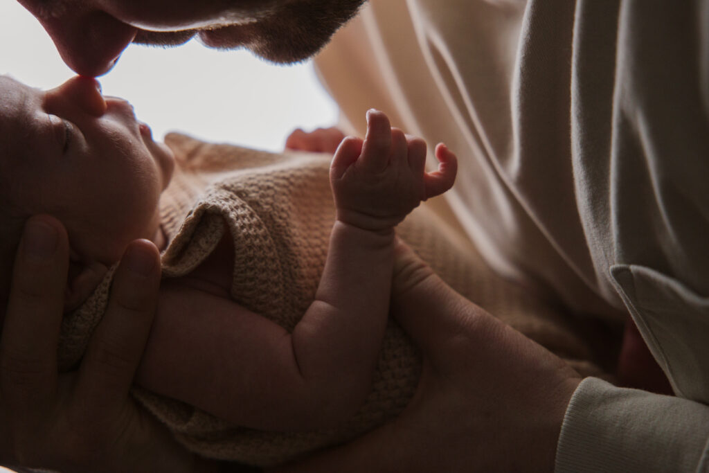 Traverse-city-michigan-newborn-photographer dad with baby during newborn family photos in traverse city