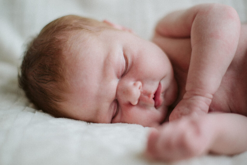 baby laying sleeping during newborn photos in traverse city michigan photographer