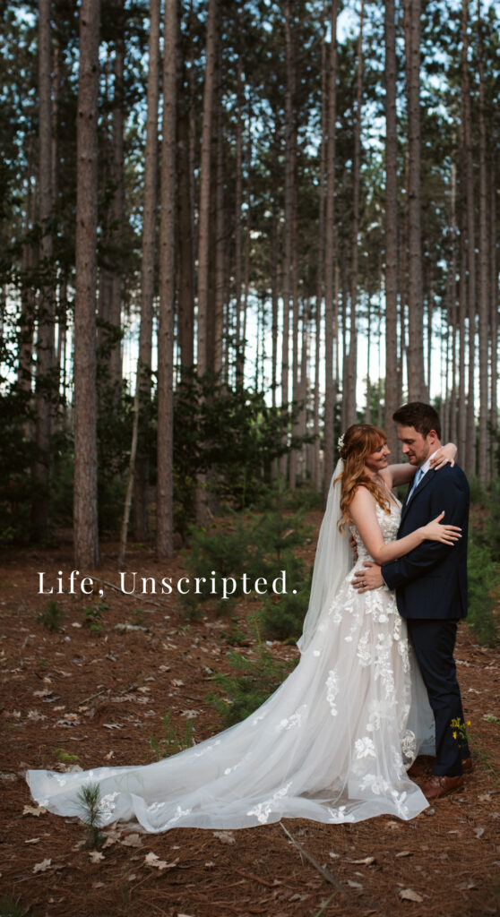 bride and groom standing in the woods laughing in traverse city michigan wedding. Northern Michigan Wedding Photographer