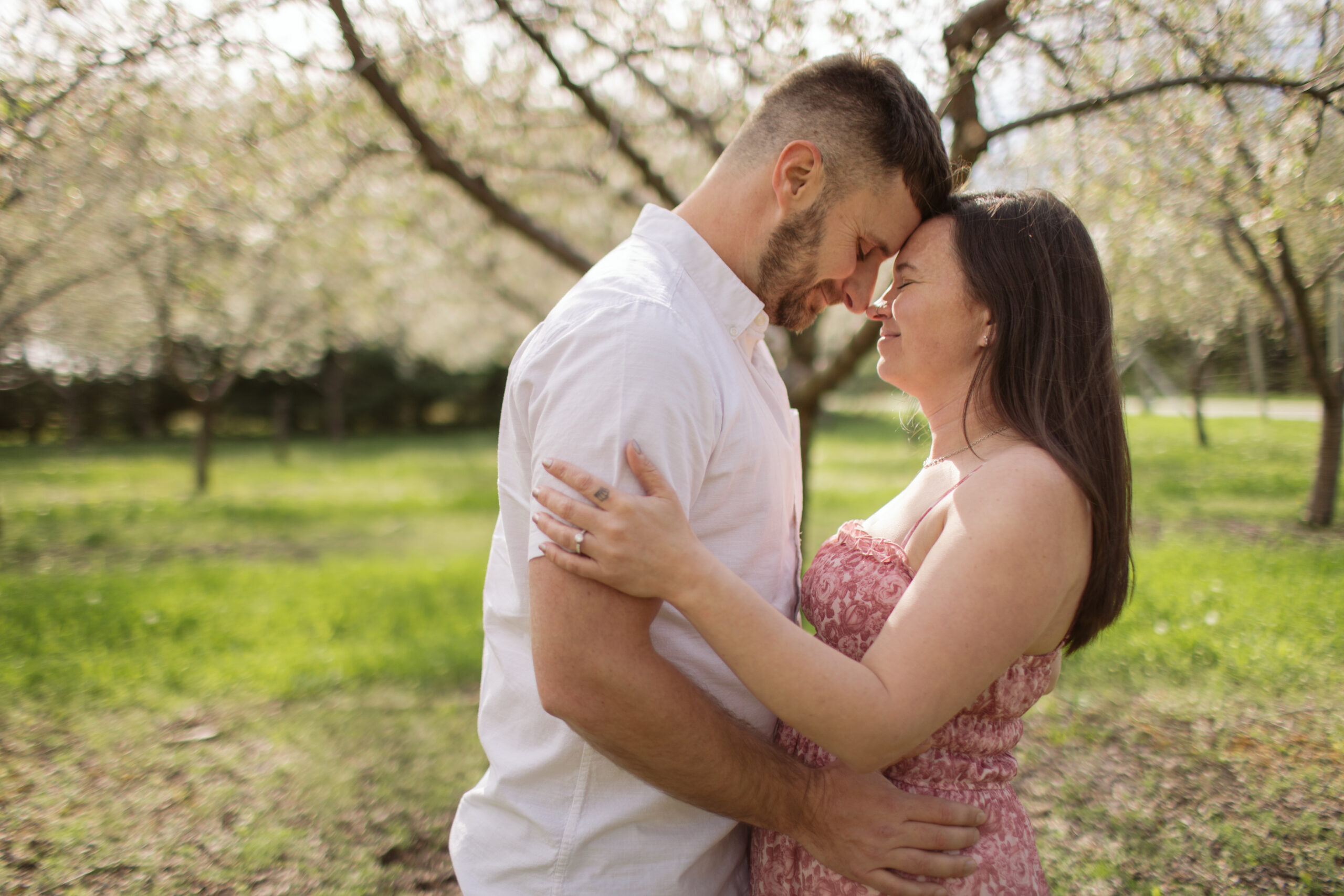 man and woman dancing during blossoms in empire michigan engagement session