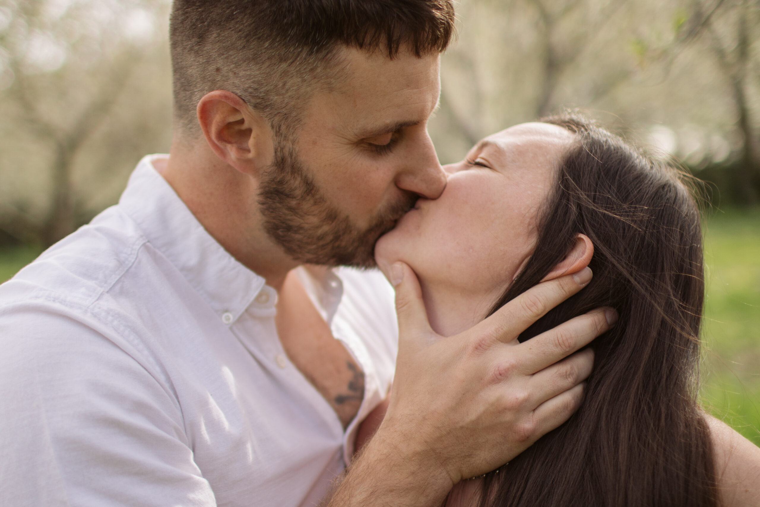 man and woman dancing during blossoms in empire michigan engagement session