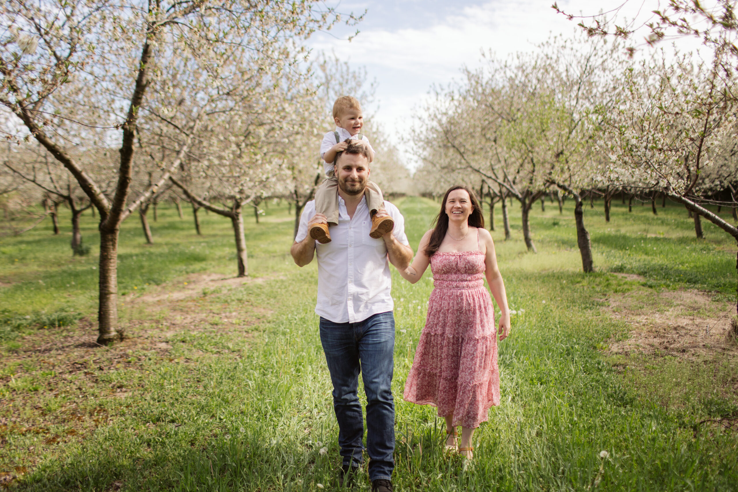 family walking during blossoms in empire michigan family session