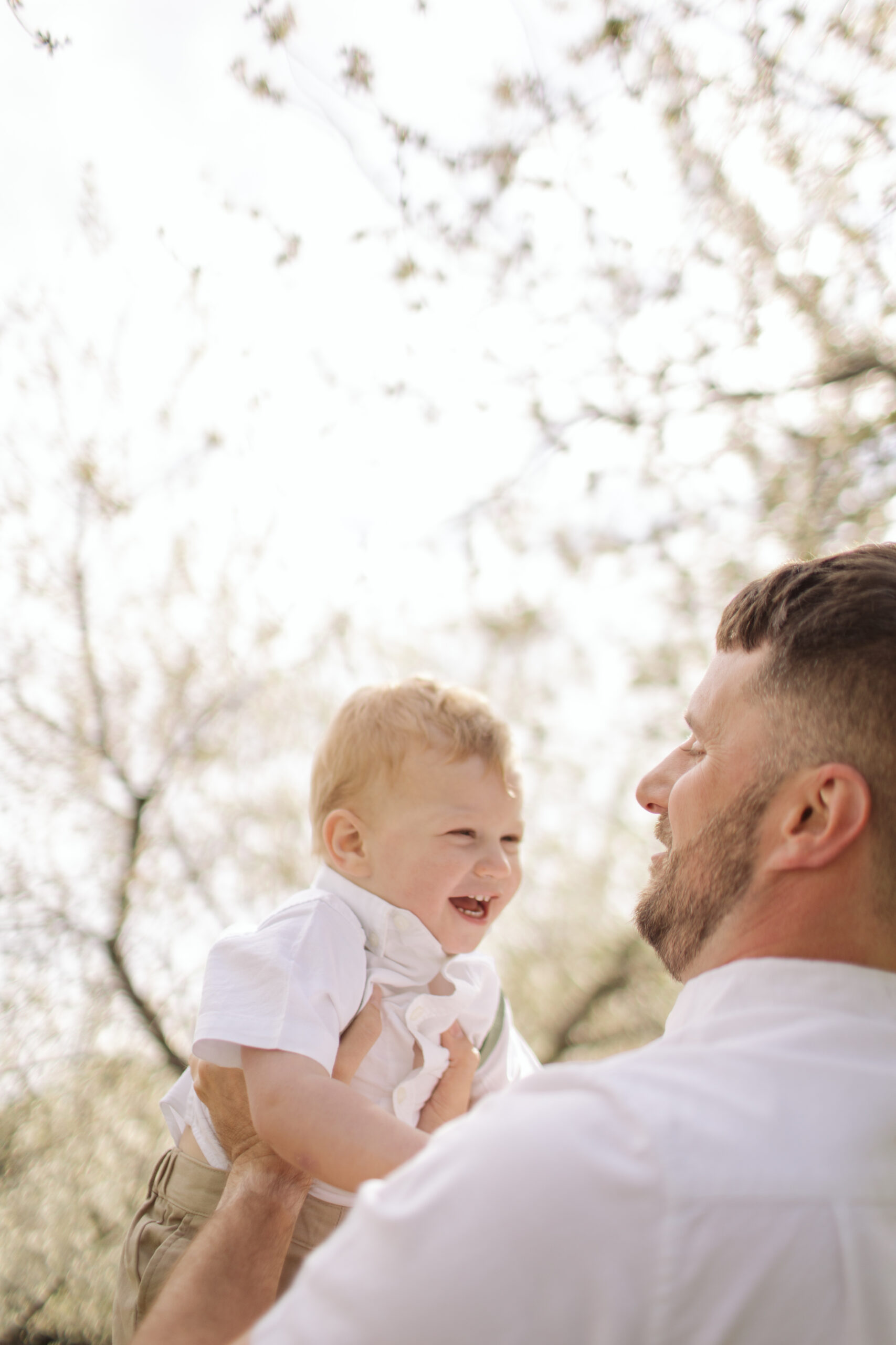 father and son during blossoms in empire michigan family session