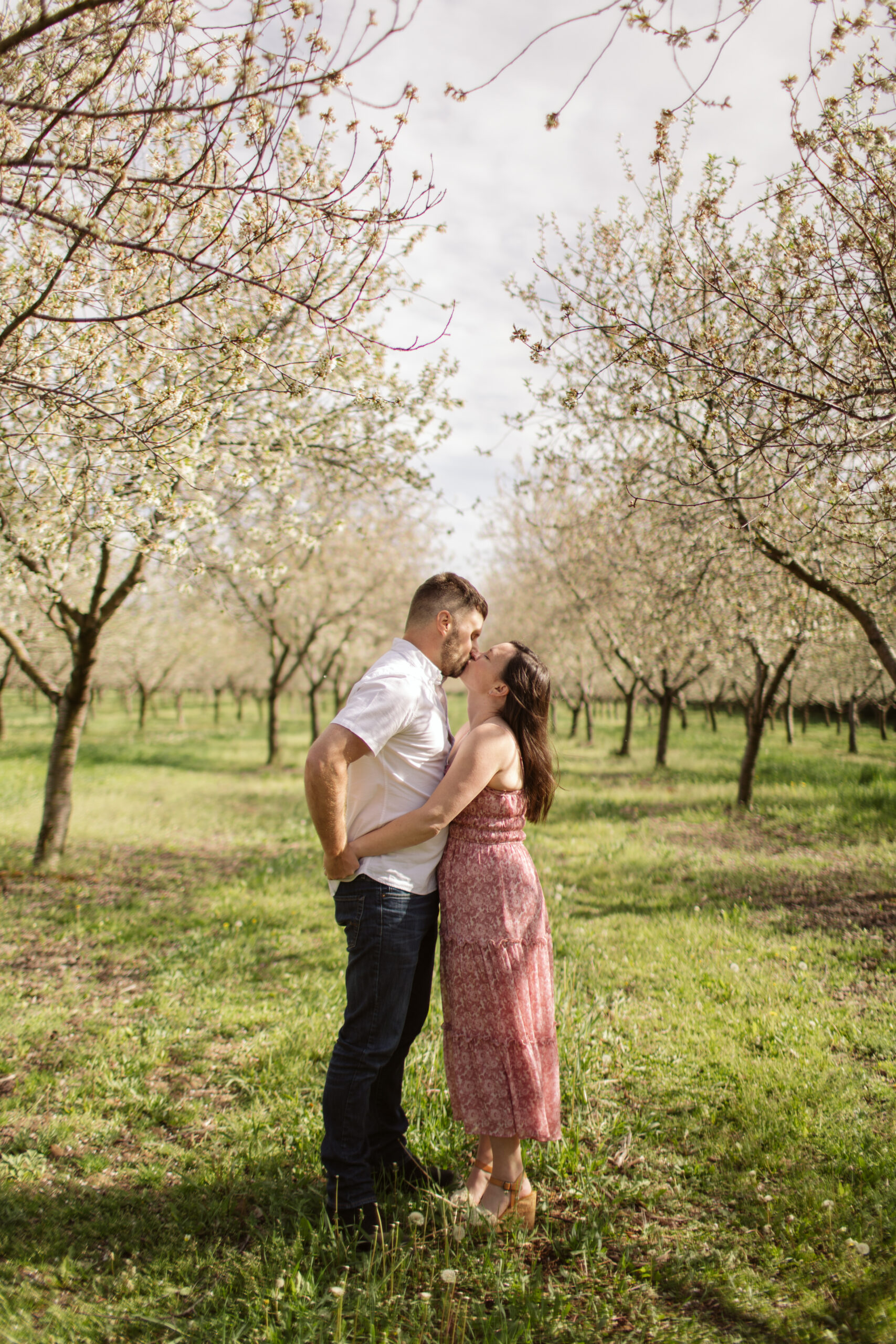 man and woman dancing during blossoms in empire michigan engagement session