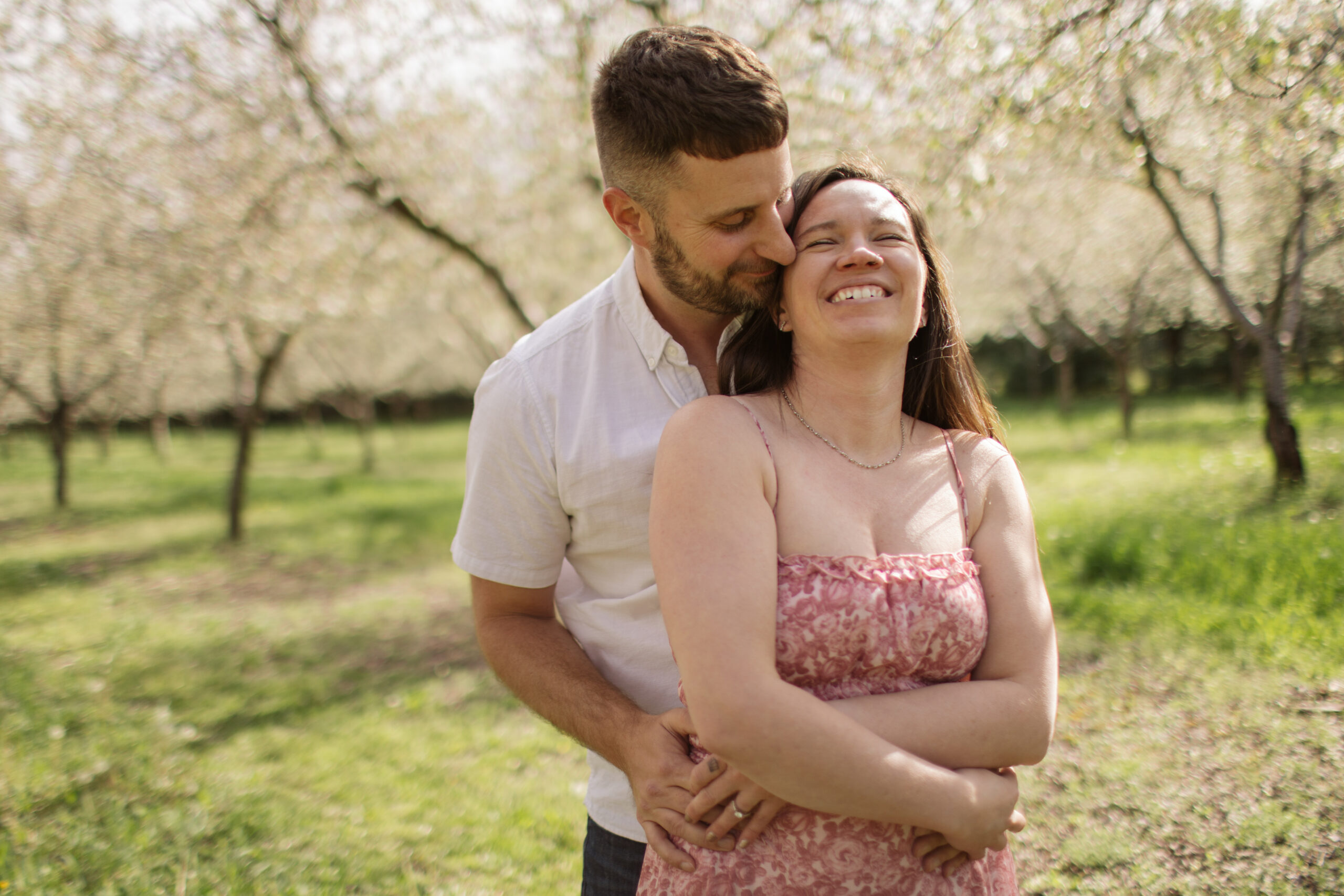 man and woman dancing during blossoms in empire michigan engagement session