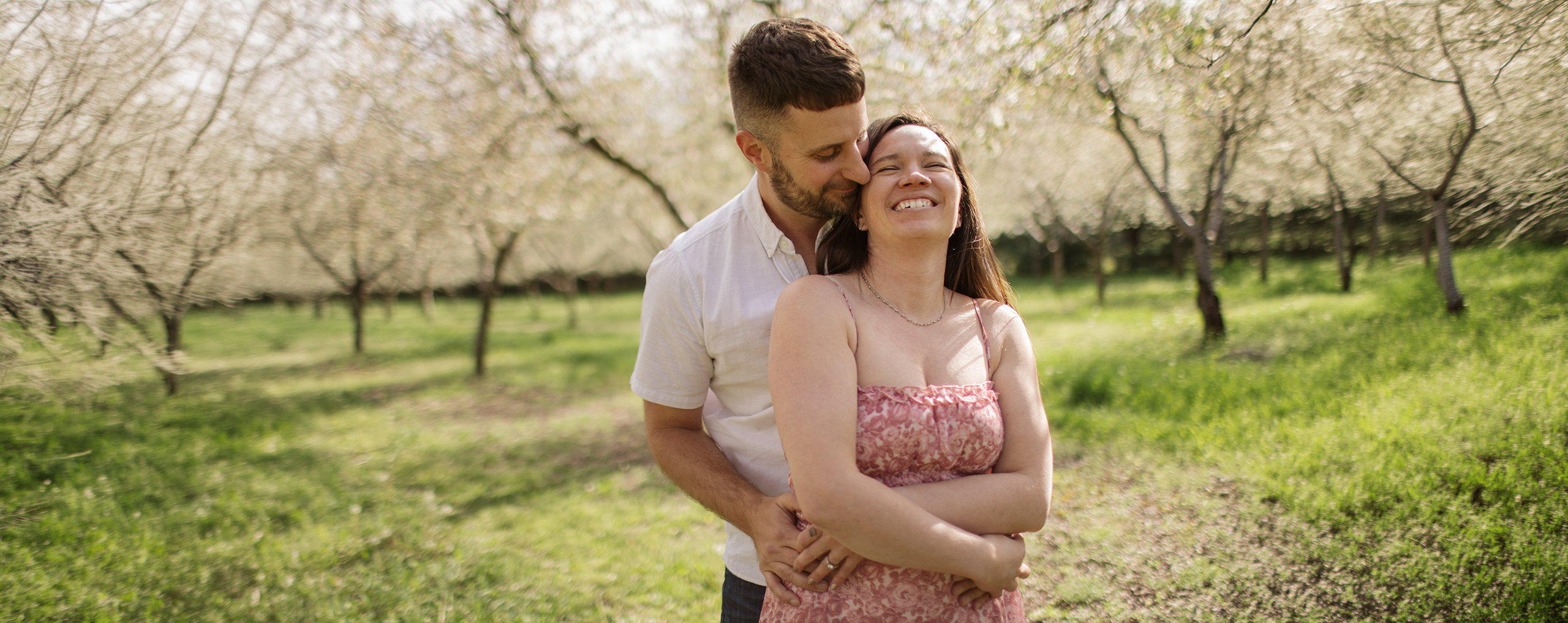 man and woman hugging in spring engagement photos