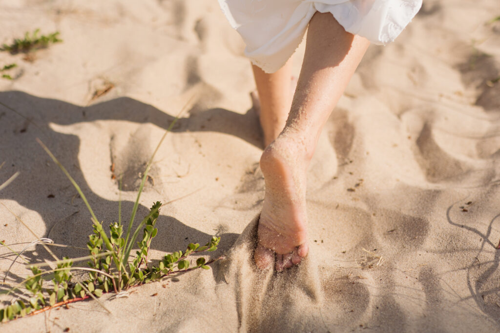 walking on glen haven beach in glen arbor michigan during engagement photos