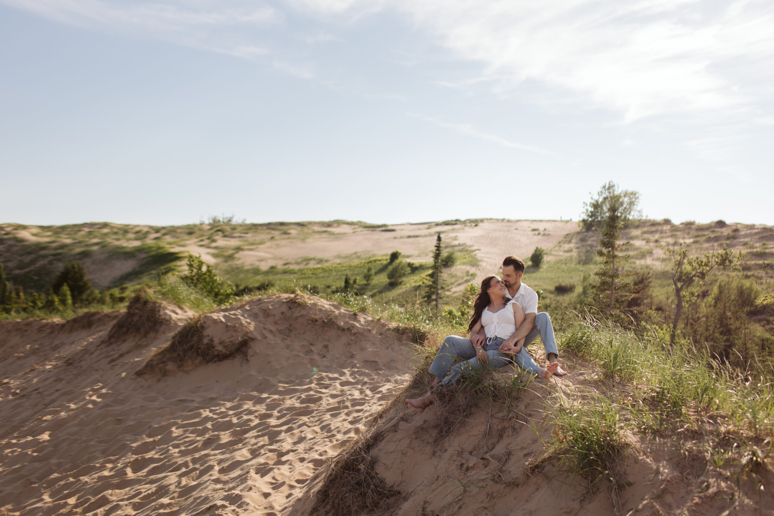 man and woman on glen haven beach in glen arbor michigan during engagement photos