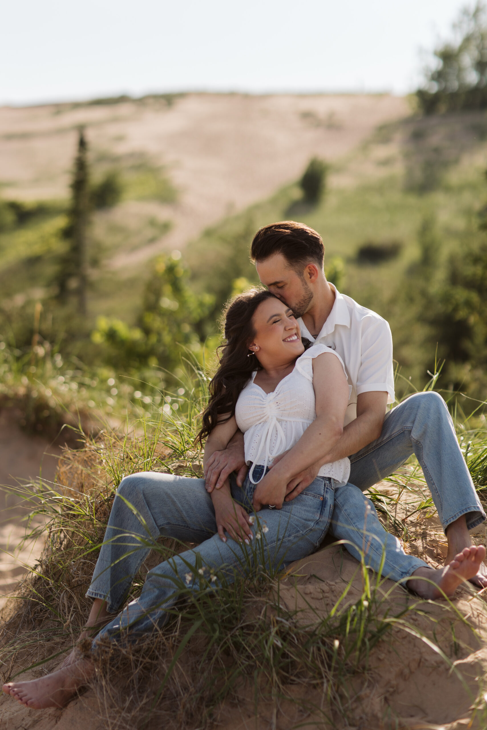 man and woman on glen haven beach in glen arbor michigan during engagement photos