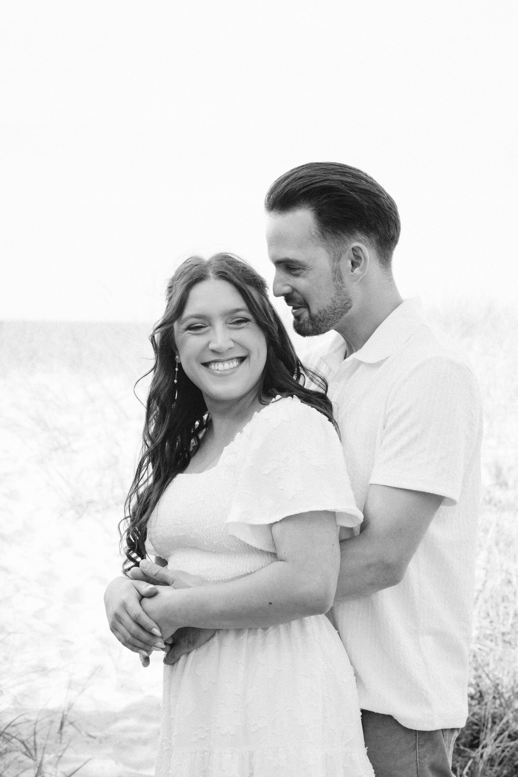 bride and groom on glen haven beach in glen arbor michigan during engagement photos