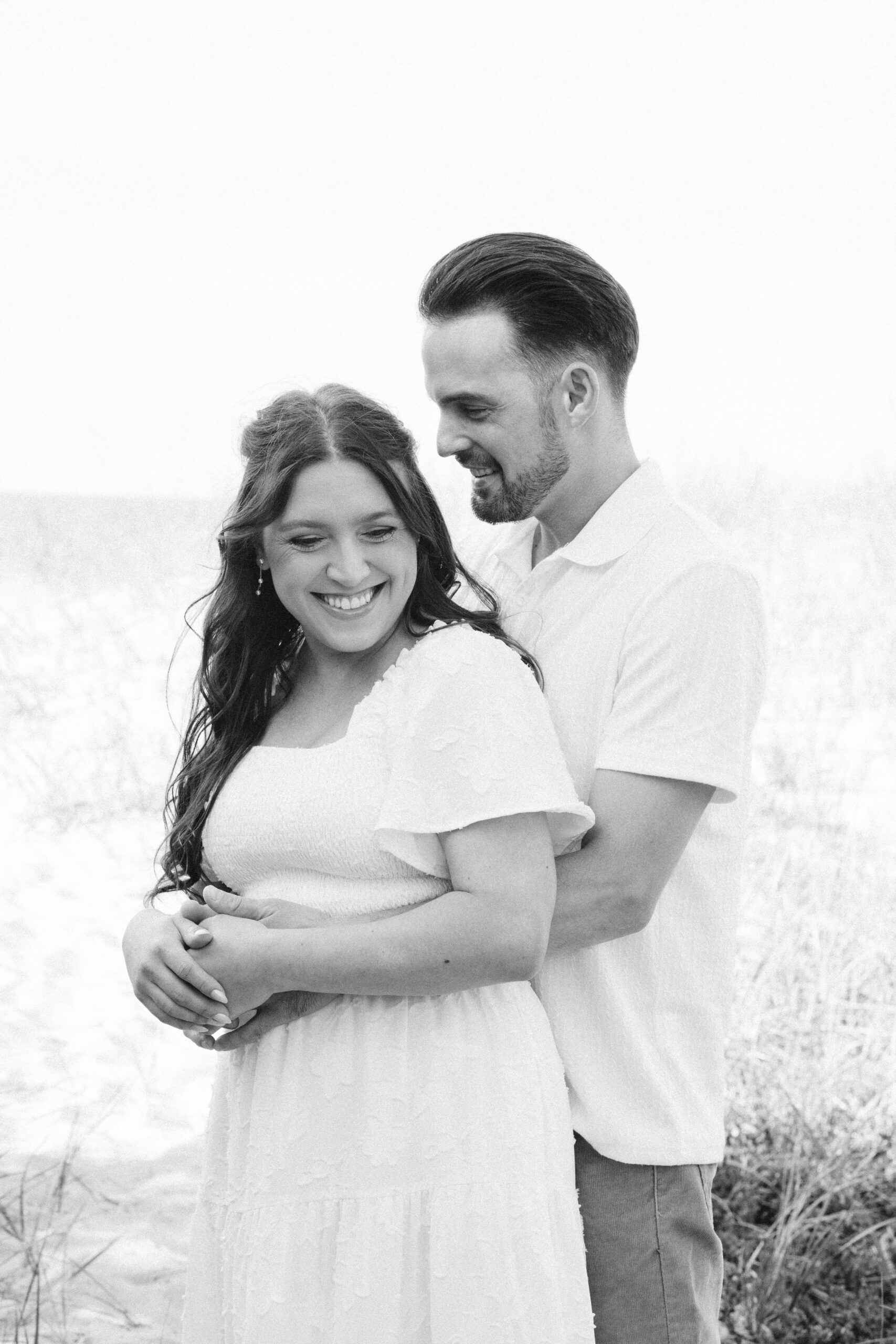 bride and groom on glen haven beach in glen arbor michigan during engagement photos