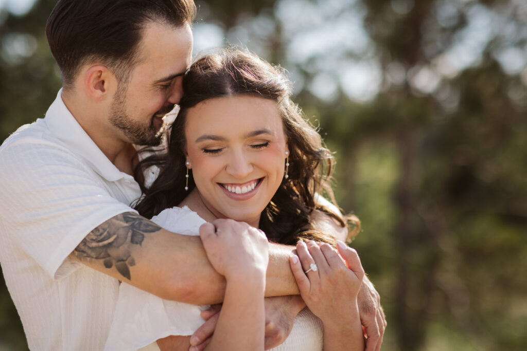 bride and groom on glen haven beach in glen arbor michigan during engagement photos