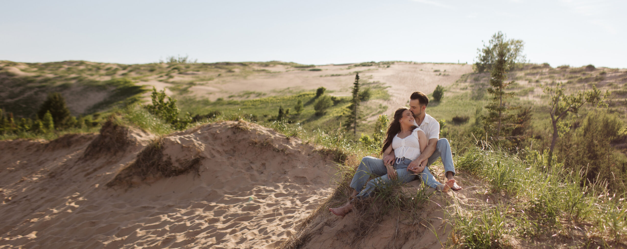 glen haven beach couple sitting on cliff top 