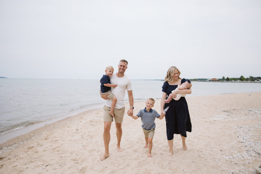 family on elk rapids beach during family photos