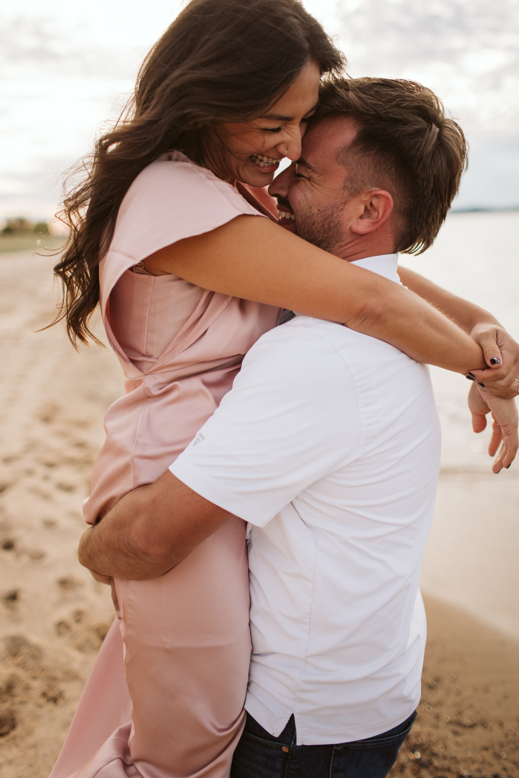 elk-rapids-wedding-photographer bride and groom walking downtown elk rapids michigan during engagement photos wedding photographer