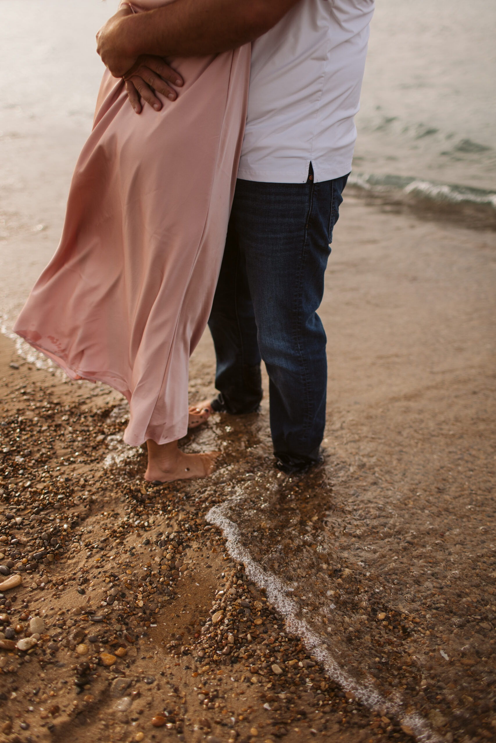 elk-rapids-wedding-photographer bride and groom walking downtown elk rapids michigan during engagement photos wedding photographer
