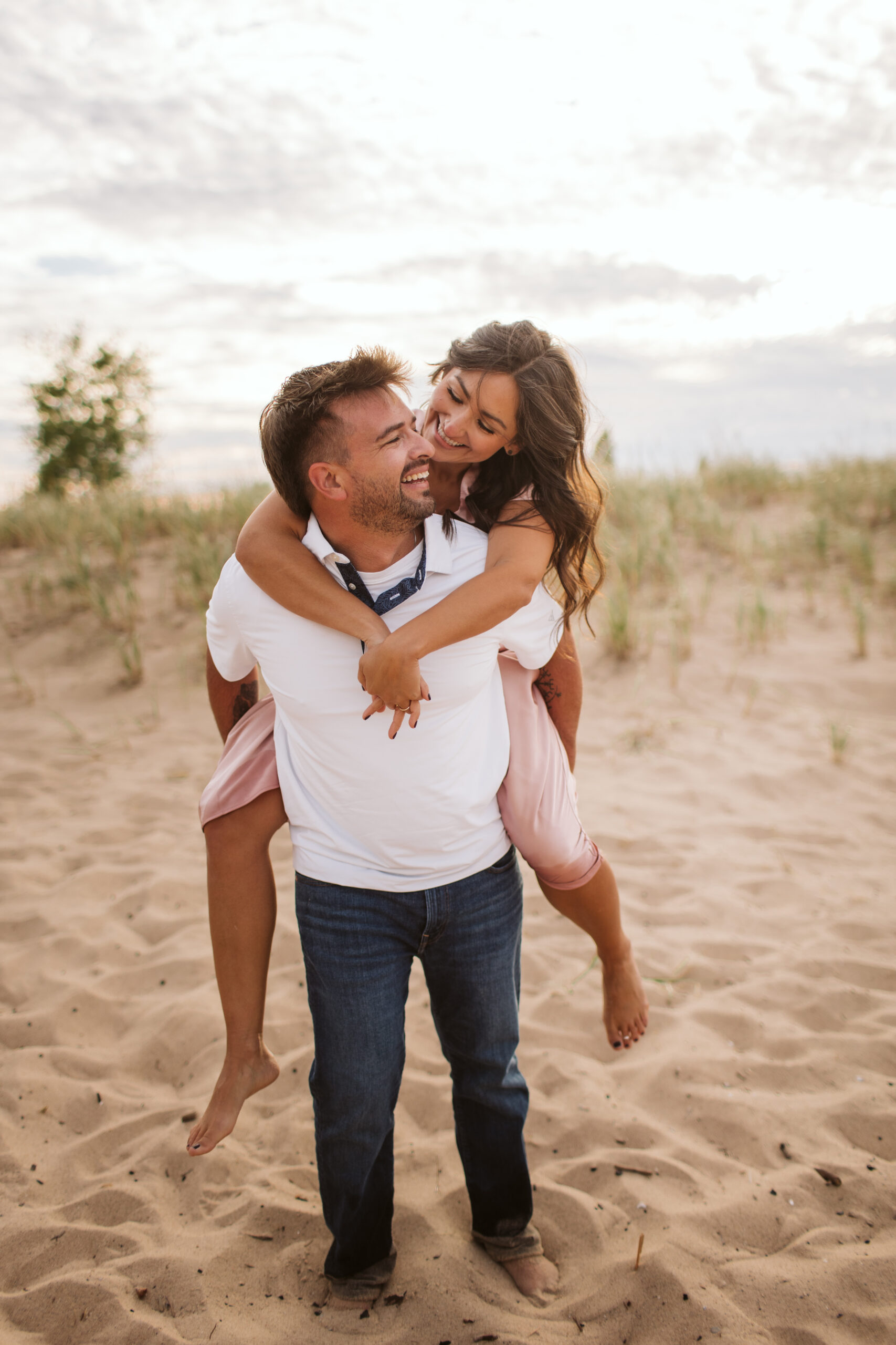 elk-rapids-wedding-photographer bride and groom walking downtown elk rapids michigan during engagement photos wedding photographer
