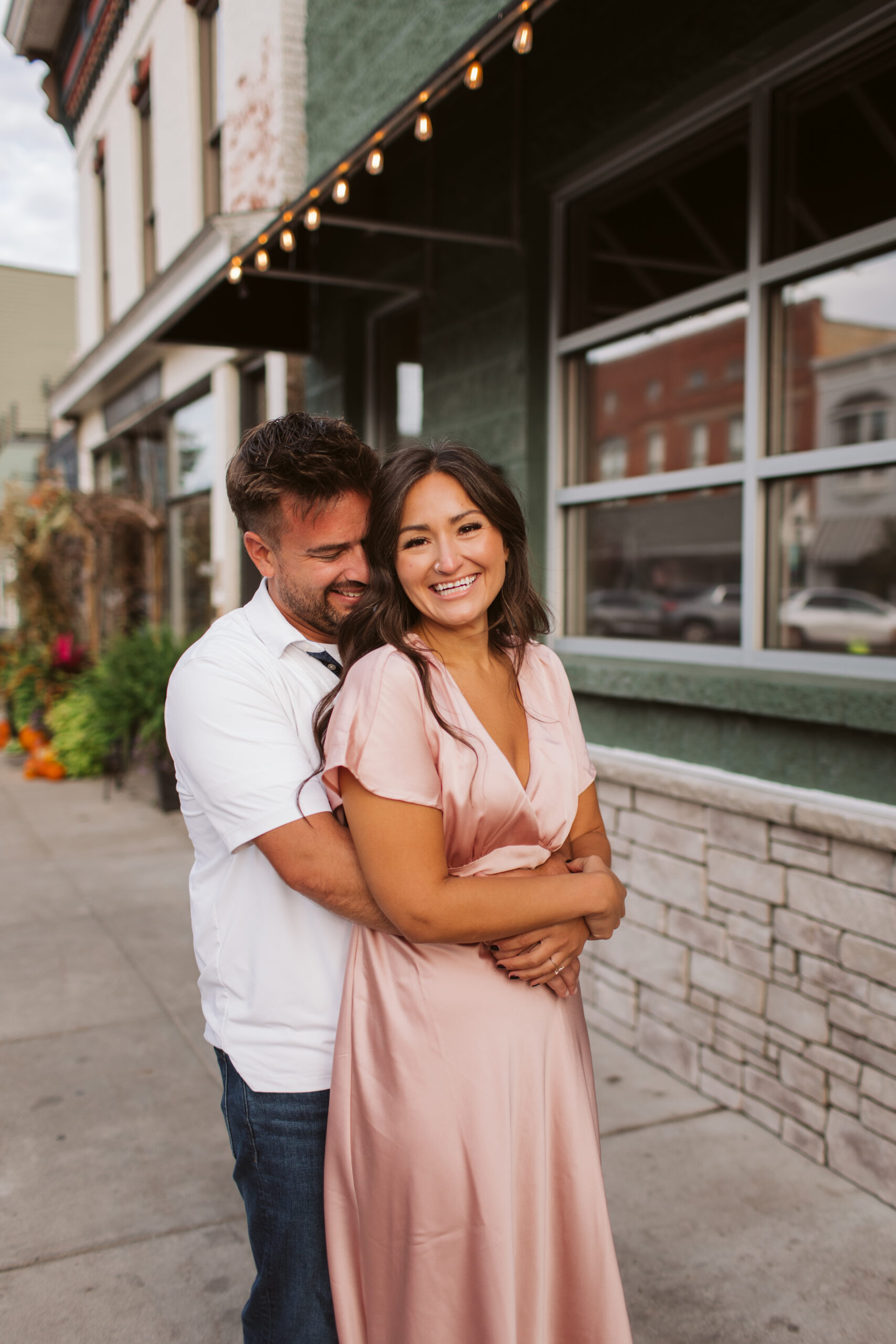 elk-rapids-wedding-photographer bride and groom walking downtown elk rapids michigan during engagement photos wedding photographer