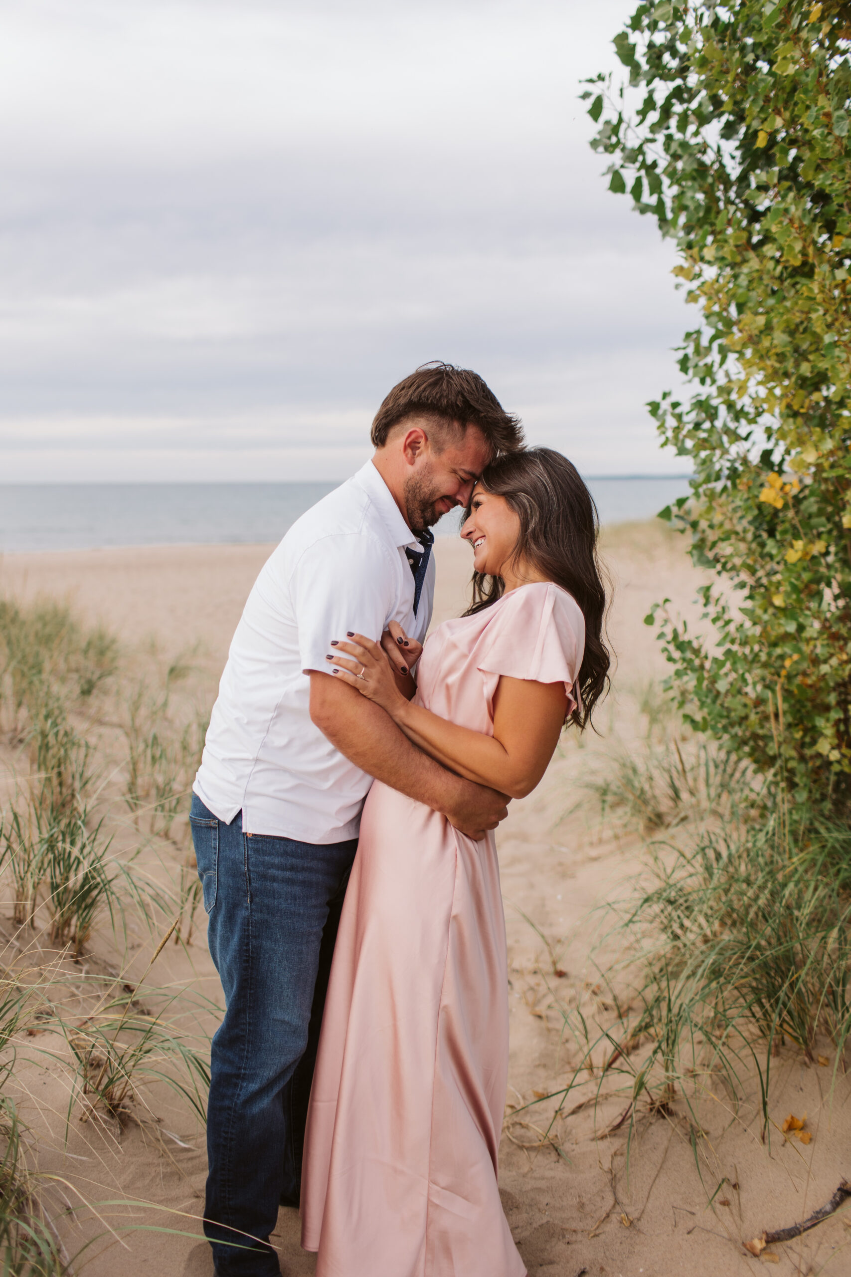 elk-rapids-wedding-photographer bride and groom walking downtown elk rapids michigan during engagement photos wedding photographer