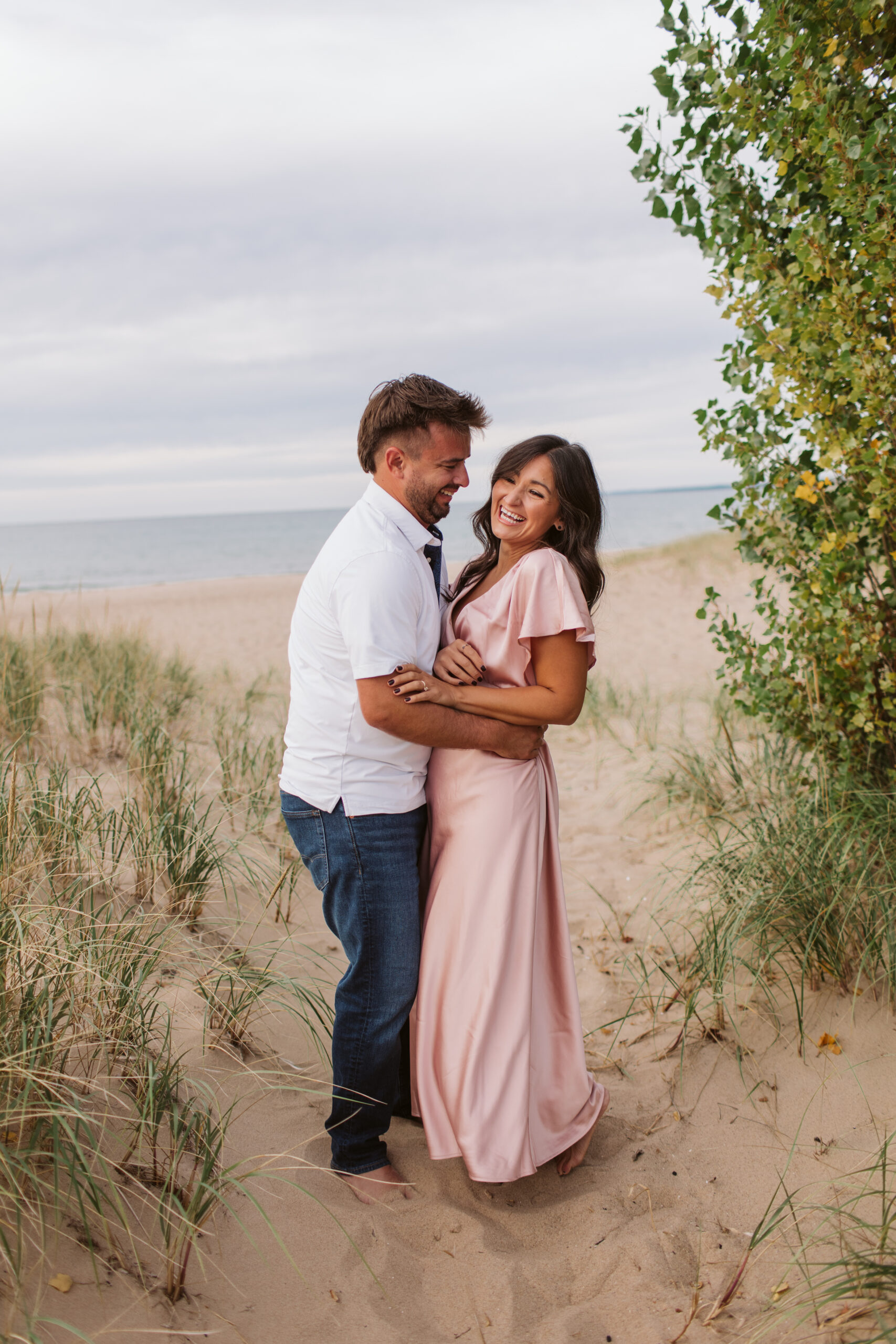 elk-rapids-wedding-photographer bride and groom on elk rapids beach in michigan during engagement photos wedding photographer